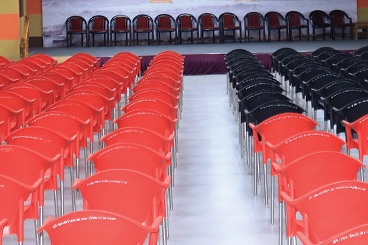 The Sagar Darshan auditorium, with rows of red and black chairs facing the stage