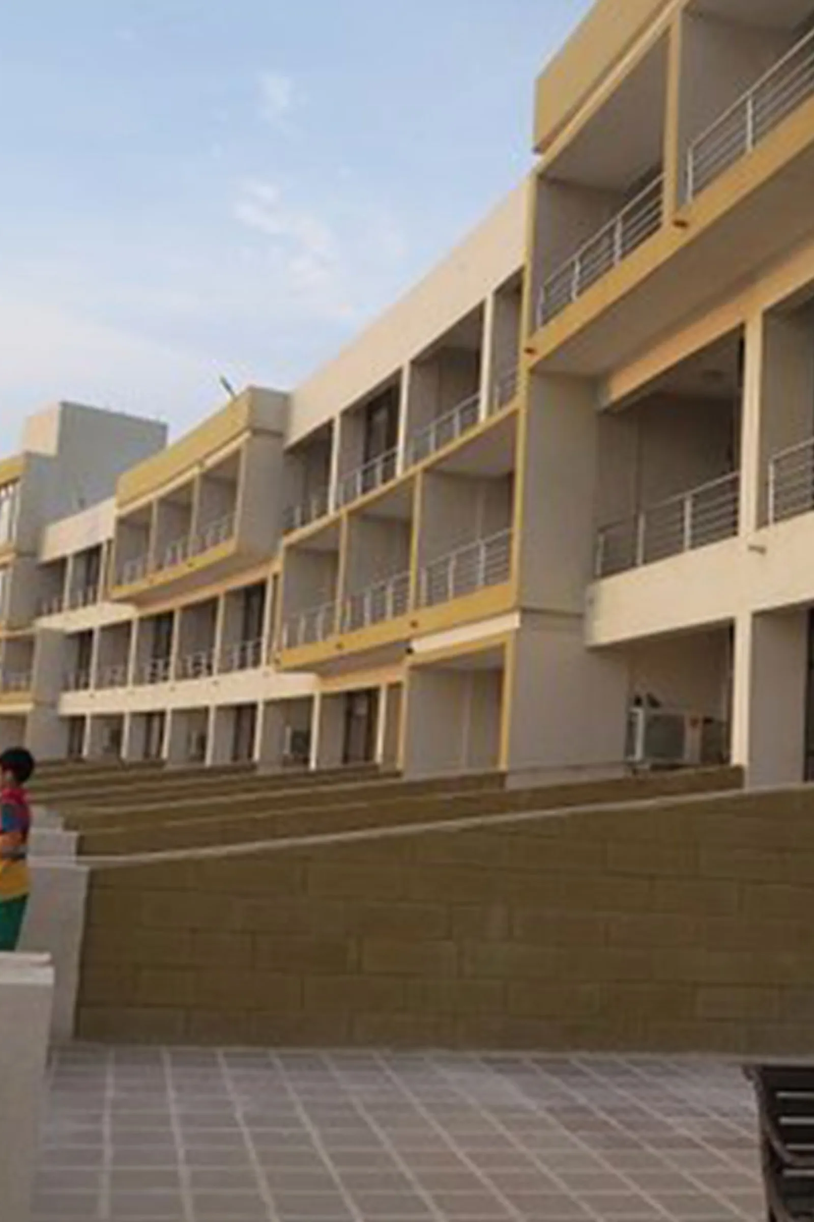 Close view of the guest house facade with rows of sea facing balconies