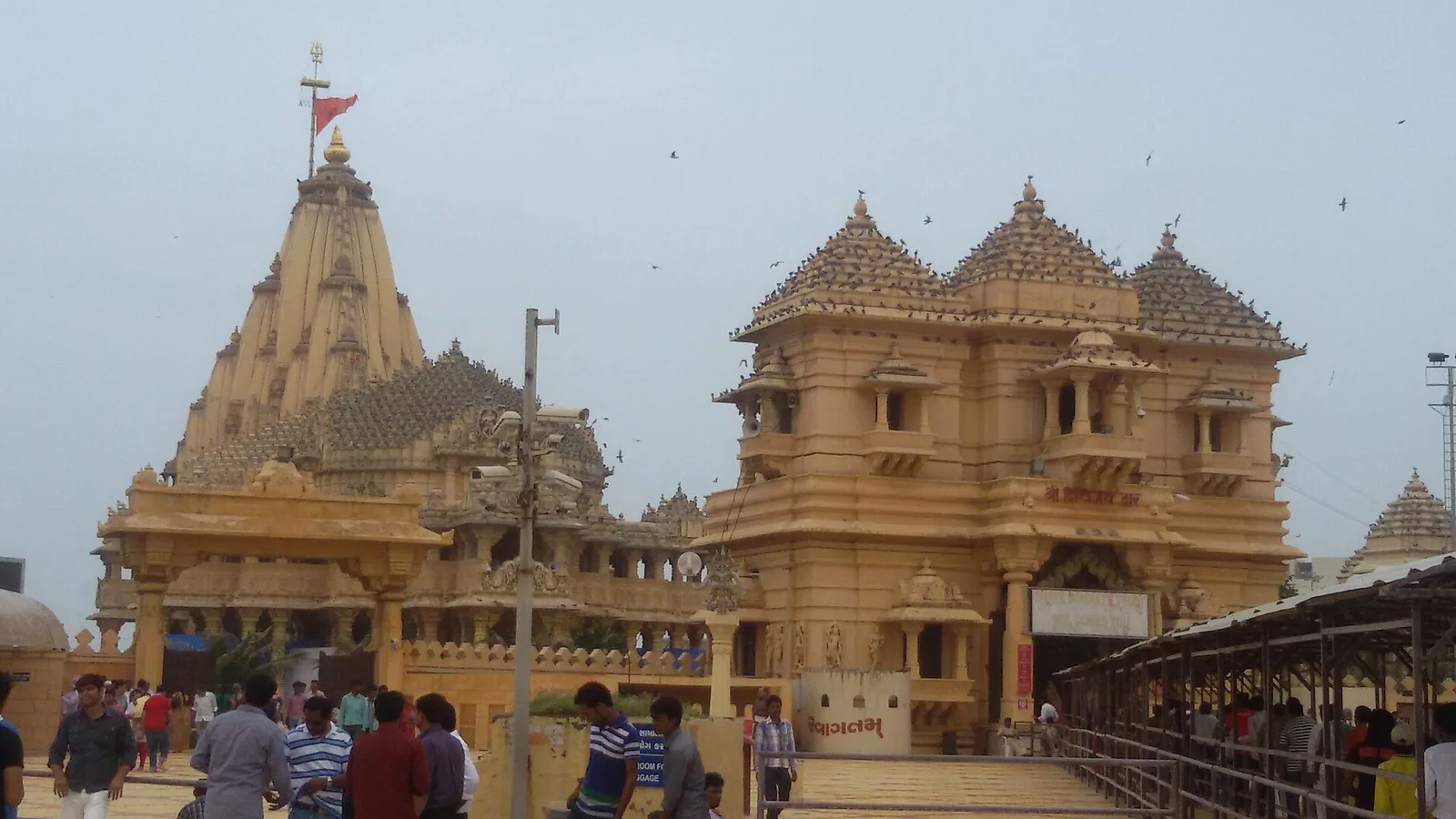 Somnath temple in Prabhas Patan, Gujarat, with its carved sandstone shikhara and pilgrims in the forecourt